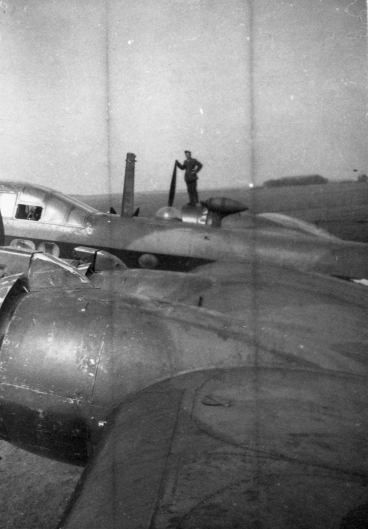 Image from the Allan Mason Forbes Alexander personal album. Unknown man standing on a starboard engine of a Stirling. Unknown location in England. Could this be a No. 75 Squadron aircraft?
